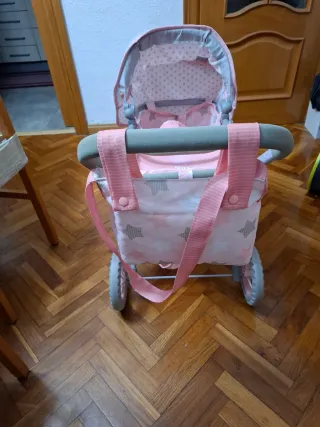 Carrito de muñecas rosa con estrellas