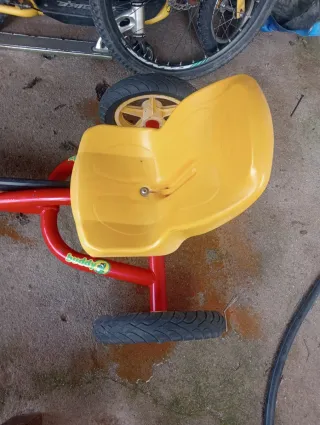 Coche a pedales rojo y amarillo