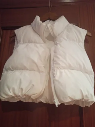 Chaleco blanco plumífero corto, elástico en final.