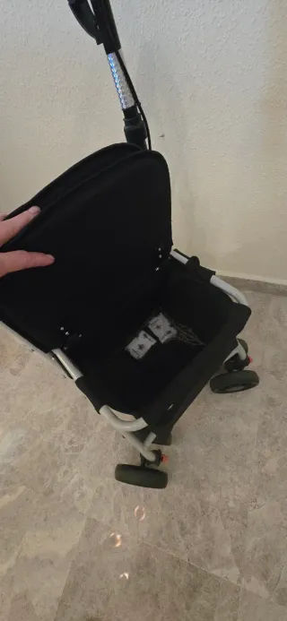 Andador ortopédico con asiento y cesta de compra.