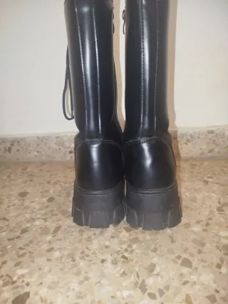 Botas altas cuero negras.