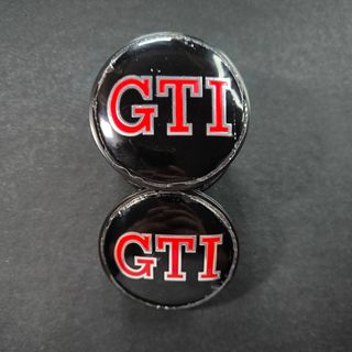 TAPABUJES VW GTI 65mm NEGROS - EMBLEMA VOLKSWAGEN