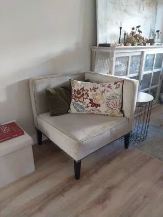 Butaca esquinera tapizada con tachuelas