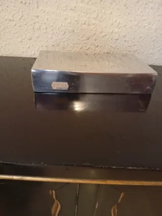 Jarrón metálico plateado.