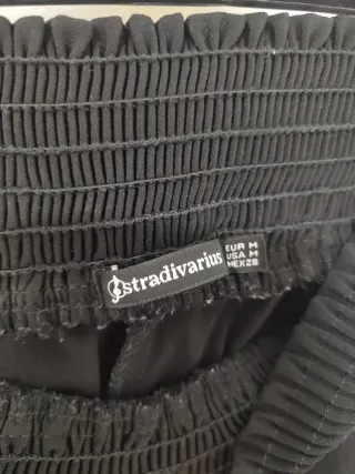 Pantalón negro con raya lateral blanca