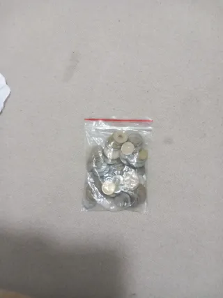 Monedas en bolsa, pesetas.