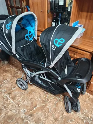 Carro gemelar plegable y con protector de lluvia