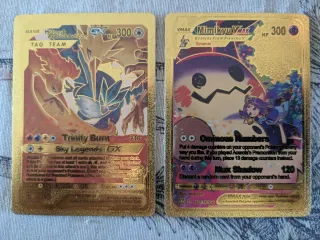 Cartas Pokémon Oro Trinity Burn y Ominous Numbers