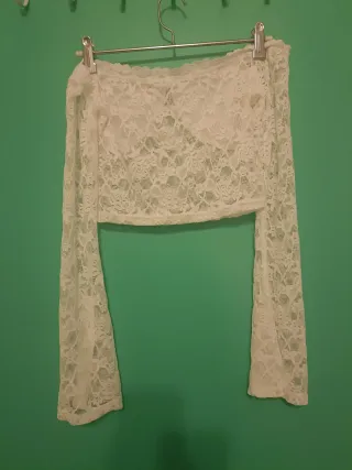 Top de encaje blanco con hombros descubiertos.