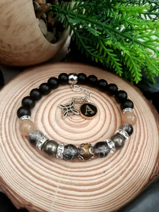 Pulsera elástica negra y dorada
