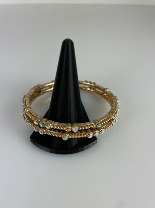 Serie 9 braccialetti dorati con inserti luminosi