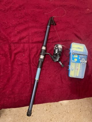 Caña de pescar y carrete con señuelos