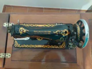Máquina de coser antigua de madera y metal.