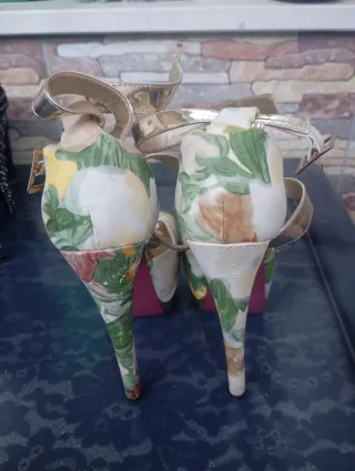 Zapatos de tacón dorados con estampado floral