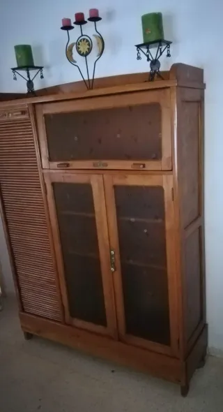 Mueble de madera con persiana y vitrina