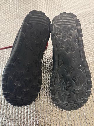 Botas de montaña Quechua negras y rojas.