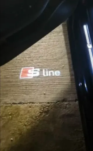 AUDI LUZ CORTESÍA EMBLEMA SLINE LOGO S