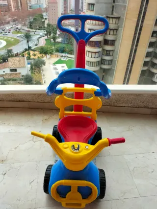 Triciclo infantil azul, rojo y amarillo