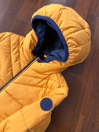 Piumino neonato arancione con cappuccio