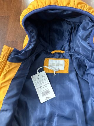 Piumino neonato arancione con cappuccio