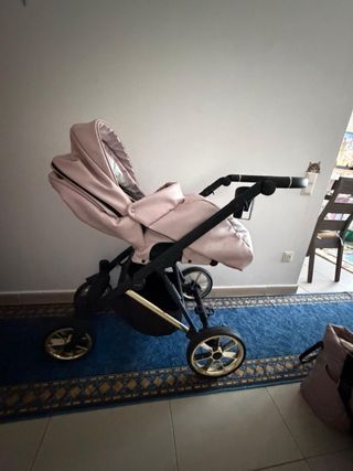 Carro de bebé rosa con capota de pelo