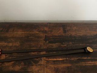 Cinturón fino marrón con hebilla dorada