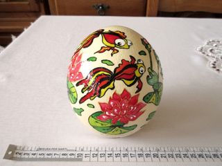 Uovo di struzzo decorato con pesci e fiori. Vuoto.