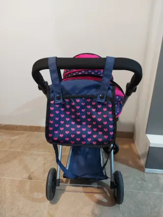 Carro gemelar de juguete con bolso