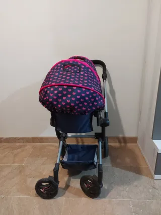 Carro gemelar de juguete con bolso