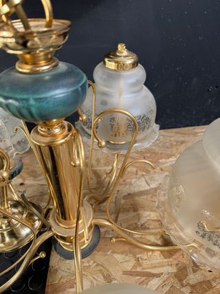 Lámpara de araña dorada con detalles verdes