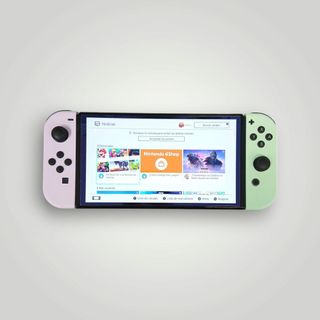 CONSOLA NINTENDO SWITCH OLED 64 GB + JOYCONS VERDE Y ROSADO + CARGADOR