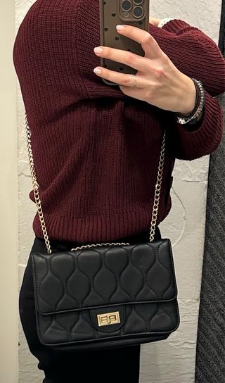 Bolso negro acolchado con cadena dorada