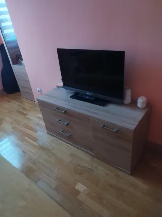 Sofá cama amarillo con cojines y muebles.