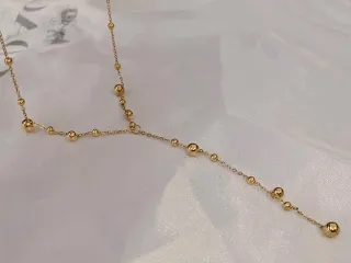 Collar de acero con esferas bañado en oro 18K
