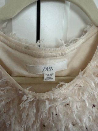 Camiseta elegante plumas lentejuelas