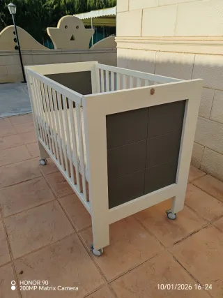 Cuna de bebé blanca con ruedas