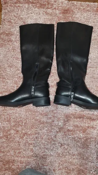 Botas altas negras con hebilla dorada