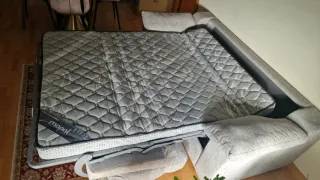 Sofá cama gris tela.