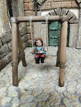 Niño pastor en columpio