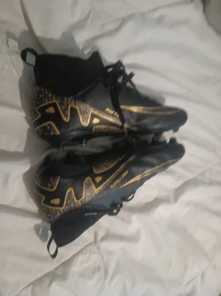Botas de fútbol Nike negras y doradas