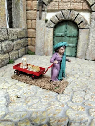 Niño pastor con gatitos en carrito