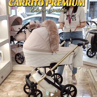 Carro de bebé rosa y blanco