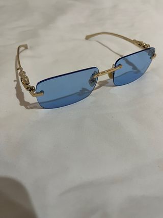 Gafas de lujo doradas y azules (Cartier)