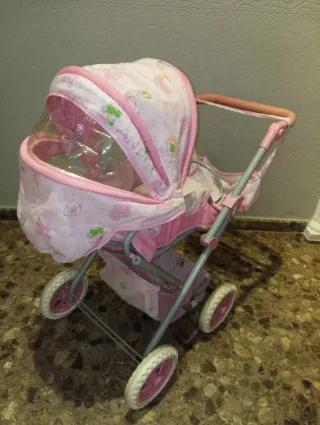 Cochecito de juguete rosa