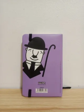 Libreta tapa dura morada con frase motivadora