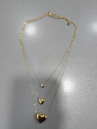H529 Collana tre fili con cuori inox oro lucida