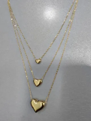 H529 Collana tre fili con cuori inox oro lucida