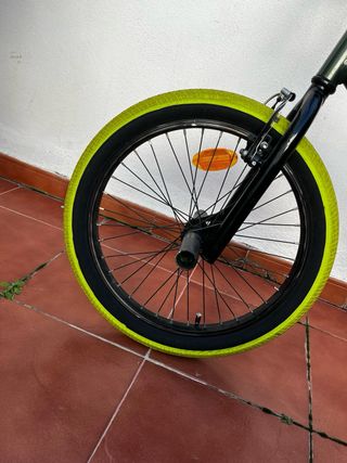Bicicleta BMX verde con ruedas amarillas