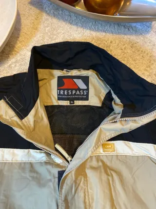 Chaqueta Trespass impermeable beige y negra