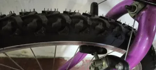 Bicicleta morada con cesta y portabultos